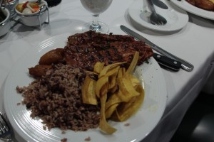 Achiote lean pork tenderloin from El Novillo served with gallo pinto, sweet plantains, and fried green plantain chips.