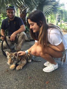 Josefina Moni, 20, a student at the University of Michigan, photographed with a tiger cub and a ZWF tour guide named Kyle. 