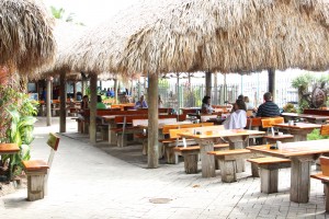 Customers relax and enjoy their seafood while sitting under the tiki huts that adorn the exterior of Monty's (Photo by Brittany Weiner).
