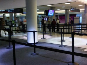 Lines at Miami International Airport, with TSA agents checking boarding passes (Photo by Brandon Lumish).