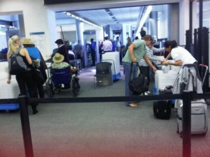 Passengers right before security, putting their belongings into bins to be checked by TSA agents (Photo by Brandon Lumish).