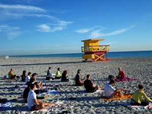 Instead of a classroom, Third Street Beach Yoga students enjoy the clear skies and crisp breeze of Miami Beach (Photo courtesy of Third Street Beach Yoga).