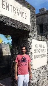 Juliana Moncada's partner stands under the "main gate" that serves as the entrance into Coral Castle (Photo by Donatela Vacca).