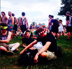 Attendees of Bonnaroo 2014 in Manchester, TN lounge on the grass while listening to various artists live.  
