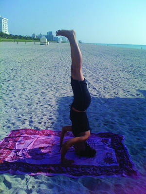 The straight line of this yoga student's body means that she has truly perfected the headstand pose (Photo courtesy of Third Street Beach Yoga).